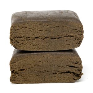 Two stacked blocks of dark pressed hash showing a dense, layered interior texture.