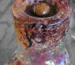 Small ball of traditional pressed hashish sitting on top of a glass pipe bowl, demonstrating the bowl-topping method.